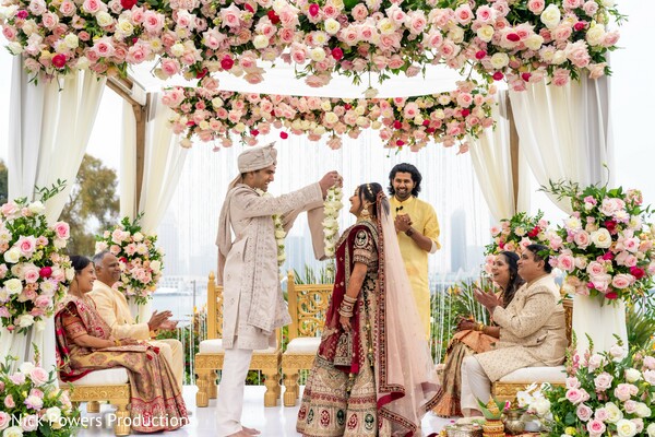 varmala ceremony,hindu wedding ritual,garland exchange,emotional wedding moment,indian wedding mandap,bride and groom ceremony,family blessings,floral mandap,sacred rituals,traditional wedding vows