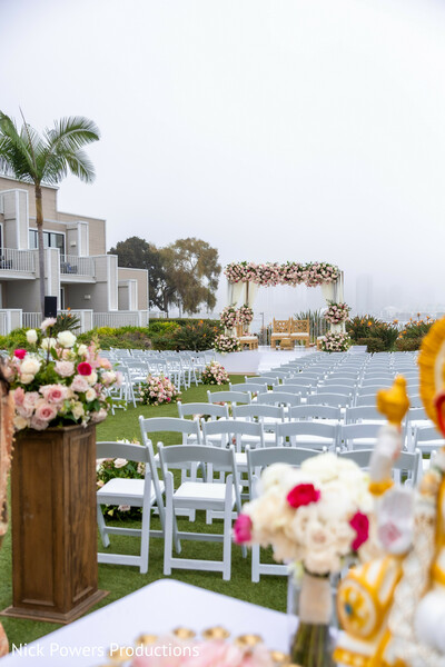 ceremony seating,outdoor wedding setup,indian wedding ceremony,mandap wide shot,wedding venue styling,aisle design,floral accents,luxury wedding layout,destination wedding ceremony,elegant decor