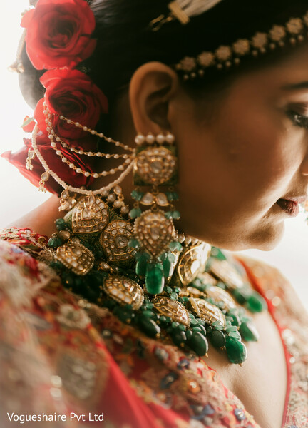bridal jewelry close-up,indian bridal earrings,emerald necklace,rose hair adornment,bridal styling,south asian wedding details,heirloom accessories,bridal profile,traditional bride,wedding fashion
