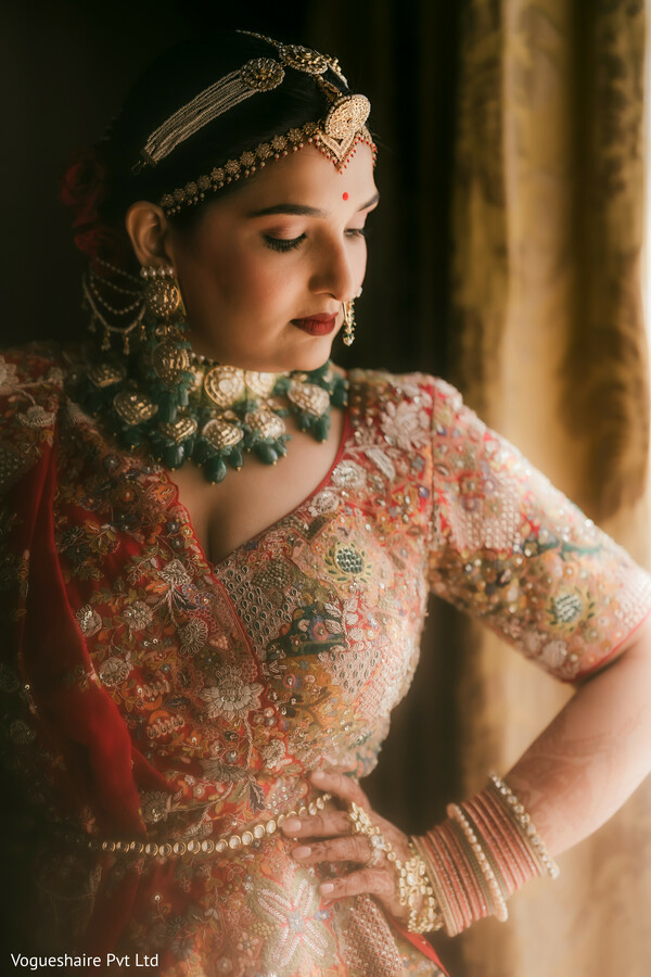bridal portrait,red bridal lehenga,indian bridal jewelry,emerald bridal necklace,bridal makeup details,heirloom jewelry,traditional indian bride,soft window light,bridal elegance,south asian wedding