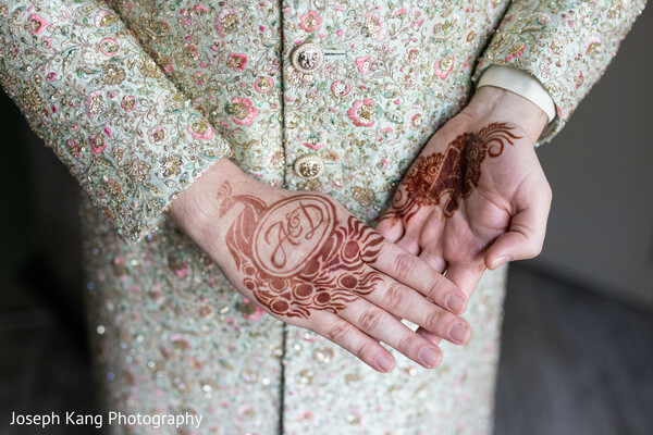 groom mehndi,henna initials,personalized wedding details,south asian wedding traditions,henna close up,meaningful symbols,wedding artistry,cultural heritage,intimate detail shot,indian wedding customs