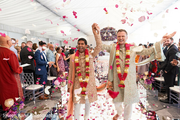 hindu wedding recessional,rose petal shower,just married moment,joyful wedding exit,garland ceremony,south asian wedding traditions,celebration aisle,newlywed happiness,emotional wedding moment,ceremony finale
