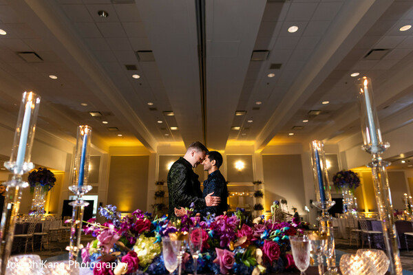 intimate wedding moment,candlelit wedding reception,romantic couple portrait,luxury ballroom decor,floral tablescape,same sex wedding love,modern indian reception,elegant wedding styling,nighttime wedding romance,heartfelt connection