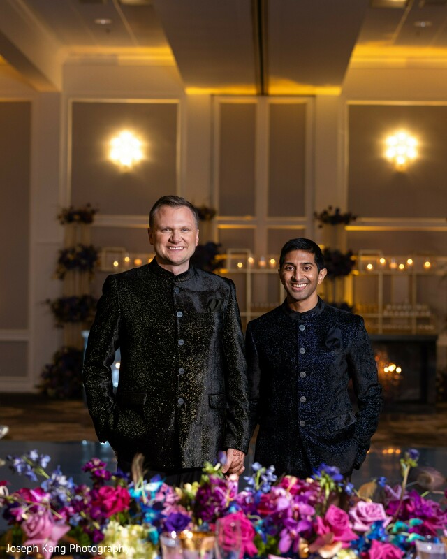 same sex wedding couple,floral reception decor,modern indian wedding style,luxury ballroom wedding,evening portraits,elegant groom attire,romantic wedding lighting,reception florals,sophisticated wedding design,celebration night