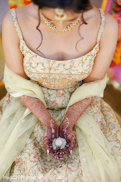 bridal mehndi,henna details,haldi ritual,ceremonial coconut,pastel lehenga,intricate embroidery,indian wedding traditions,close up bridal details,sacred symbolism,pre wedding moments
