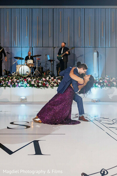 first dance dip,wedding reception dance,live wedding band,purple reception gown,romantic dance moment,ballroom wedding reception,emotional wedding moment,couple dancing,modern wedding celebration,luxury reception decor