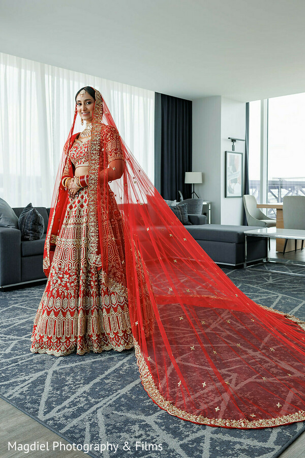 bridal portraits,red lehenga,bridal veil drama,indian bride style,wedding fashion,modern bridal prep,luxury bridal look,south asian bridal wear,wedding day elegance,statement bridal attire