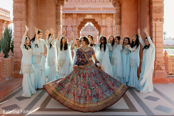 bridesmaids in pastel blue,bridal twirl portrait,destination wedding courtyard,coordinated bridal party outfits,lehenga detail shot,luxury wedding photography,palace venue wedding,joyful bridal moment,south asian bridal squad,heritage wedding backdrop