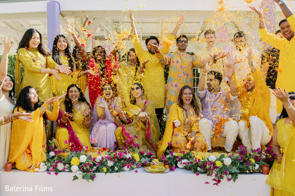 haldi ceremony,marigold petals toss,yellow wedding outfits,south asian pre-wedding ritual,bride at haldi,joyful wedding celebration,indian wedding traditions,floral decor styling,vibrant wedding energy,family haldi moment