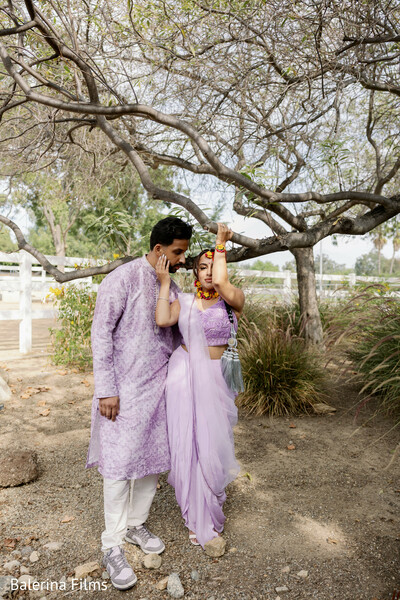 lavender sari bride,floral jewelry haldi,groom in lilac kurta,pre-wedding portrait,outdoor engagement shoot,natural wedding photography,romantic couple moment,pastel wedding fashion,indian pre-wedding style,garden couple portrait