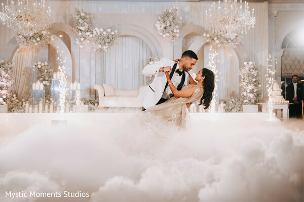 first dance dip,reception fog effect,wedding sparklers,romantic dance moment,luxury ballroom reception,bride in champagne lehenga,groom in tuxedo,dramatic wedding photography,south asian reception dance,elegant wedding celebration