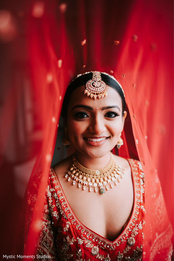 red bridal dupatta,traditional indian bride,gold bridal jewelry,bridal close-up portrait,red lehenga blouse detail,wedding day glam,south asian bridal styling,regal bridal look,classic hindu wedding attire,elegant bridal photography