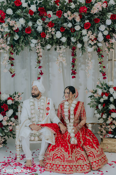 bridal mehndi detail,red chooda bangles,polki necklace set,maang tikka headpiece,bridal nose ring,close-up bridal portrait,intricate henna design,red silk blouse embroidery,hindu bridal jewelry,elegant wedding beauty