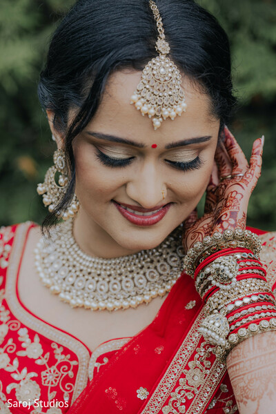 romantic close-up portrait,bridal bindi detail,gold chandelier earrings,embroidered sherwani collar,intimate wedding moment,south asian couple portrait,soft smile expression,luxury bridal jewelry,emotional wedding connection,traditional hindu attire