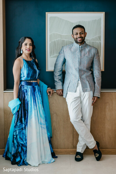 reception couple portrait,blue wedding outfits,modern south asian fashion,groom sherwani jacket,elegant couple styling,contemporary wedding portrait,indoor wedding photography,stylish wedding attire,fusion wedding style,luxury wedding fashion