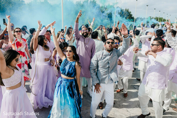 baraat dancing crowd,indian wedding celebration,colorful wedding guests,outdoor wedding party,south asian wedding dancing,festive wedding atmosphere,joyful wedding moment,destination wedding celebration,traditional baraat energy,wedding dance floor