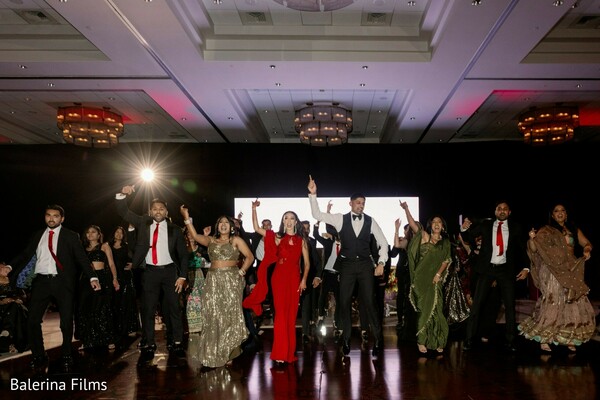 wedding reception dance performance,lively wedding party,ballroom wedding celebration,south asian reception entertainment,group dance performance,vibrant reception moment,wedding dance floor energy,modern indian wedding celebration,festive wedding party,reception entertainment