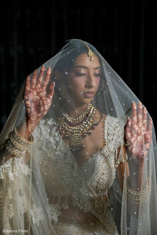 bridal veil portrait,elegant indian bride,bridal mehndi hands,traditional bridal jewelry,soft bridal portrait,wedding preparation moment,luxury bridal styling,south asian bridal beauty,romantic bridal photography,timeless bridal elegance