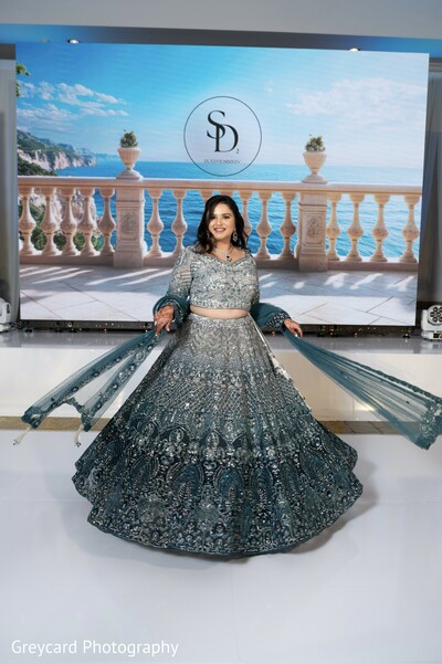 teal bridal lehenga,reception fashion portrait,modern south asian bride,sparkling bridal outfit,wedding stage backdrop,elegant reception attire,luxury indian wedding fashion,glamorous bridal portrait,contemporary wedding styling,statement bridal look