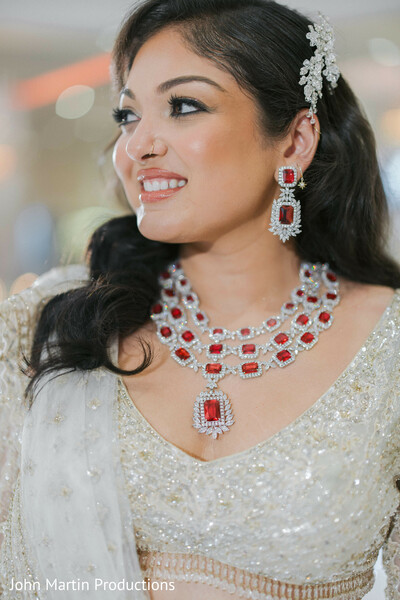 bridal jewelry close-up,red gemstone necklace,indian bride makeup,luxury bridal accessories,elegant bridal portrait,reception bridal look,south asian bride style,wedding beauty details,bridal hairstyle accessory,glamorous bride portrait