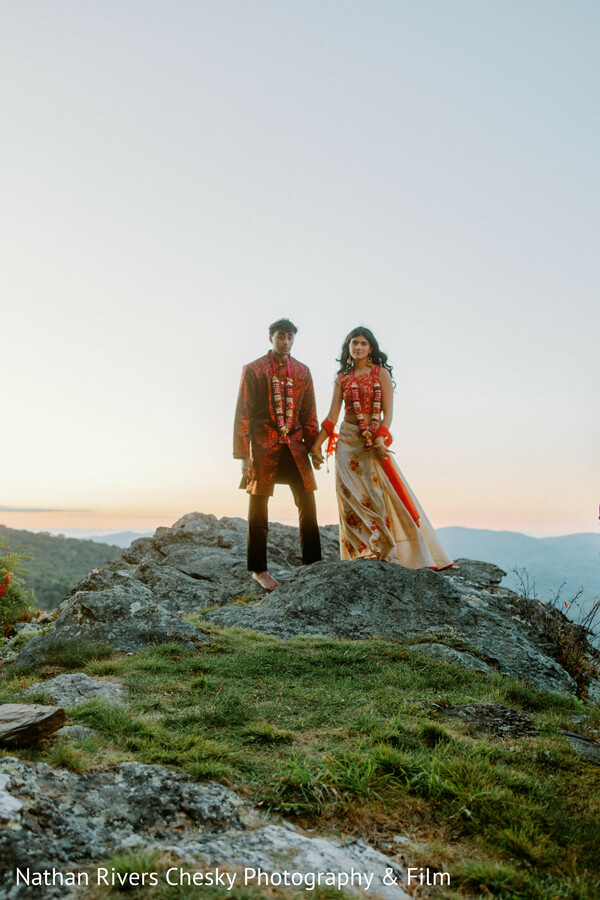 mountain couple portrait,scenic engagement shoot,destination wedding photography,cliffside couple,indian wedding outfit,nature backdrop,dramatic sky portrait,south asian couple,outdoor wedding shoot,cinematic photography