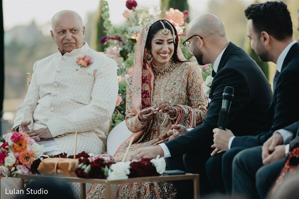 wedding ceremony candid,bride smiling moment,family interaction wedding,indian bride lehenga,emotional wedding moment,ceremony seating,cultural wedding traditions,bride laughing candid,intimate wedding exchange,wedding joy