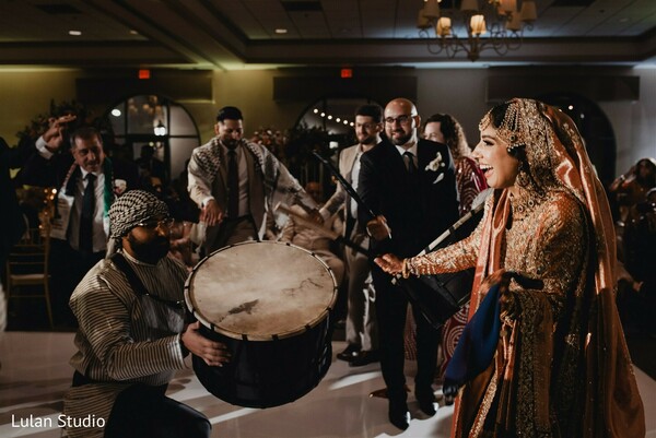 dhol performance wedding,bride dancing,indian wedding entertainment,reception energy,live drummers,bride celebration moment,cultural wedding music,wedding dance floor,joyful bride,lively wedding scene