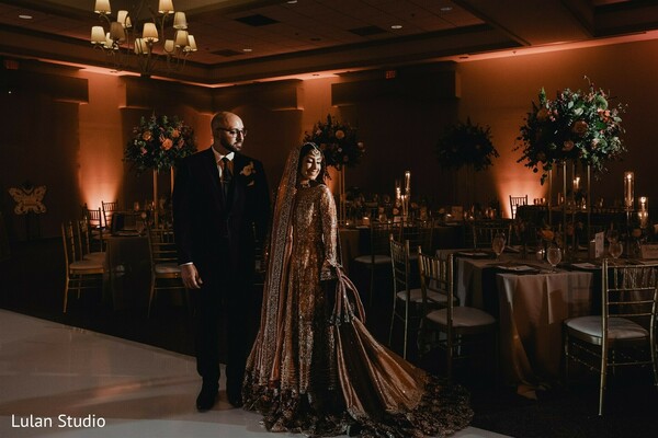 reception entrance,ballroom wedding decor,candlelight wedding,floral centerpieces,bride groom portrait indoor,elegant reception setting,indian wedding reception,romantic lighting,wedding ambiance,luxury wedding decor