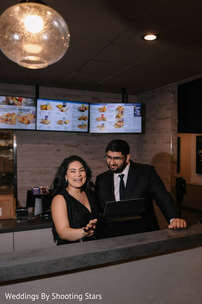 candid couple moment,casual setting portrait,bride black outfit,groom suit black,modern indian couple,relaxed wedding vibe,behind the scenes feel,couple interaction,lifestyle portrait,authentic moment