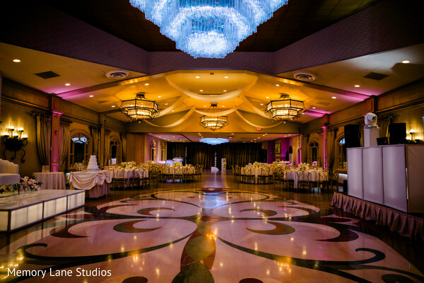 reception ballroom decor,chandelier lighting wedding,elegant dance floor,luxury wedding venue,ballroom setup,wedding reception design,ambient lighting decor,formal event space,upscale wedding,reception details