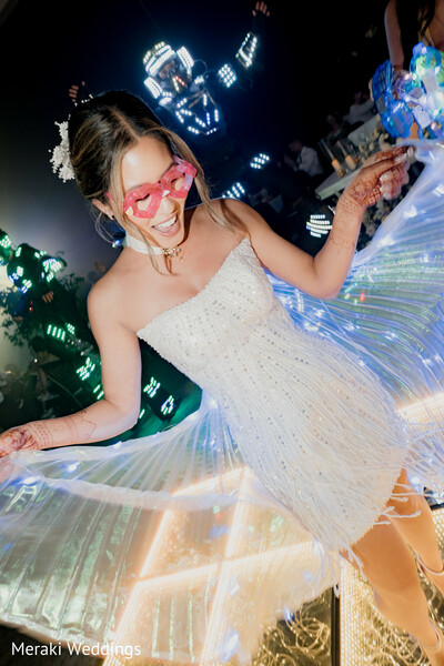 reception party bride,led wings performance,wedding dance moment,modern bridal outfit,party entertainment wedding,fun reception vibe,bride candid dancing,neon light show,wedding celebration energy,unique reception look