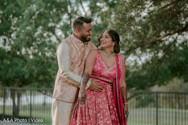 romantic couple portrait,outdoor pre wedding shoot,bride pink lehenga,groom pastel sherwani,candid couple moment,nature backdrop wedding,joyful couple embrace,mehndi visible bride,indian engagement portrait,love story capture