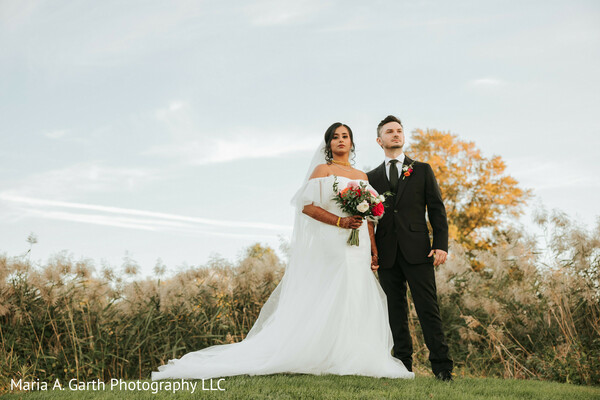 fusion wedding couple,bride white gown,groom black suit,outdoor portrait couple,modern wedding style,multicultural wedding,romantic outdoor pose,western wedding attire,elegant couple portrait,wedding photoshoot