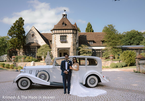 wedding couple vintage car,luxury estate wedding,bride white gown groom tuxedo,classic wedding portrait,outdoor estate backdrop,romantic couple pose,western wedding style,timeless wedding photography,elegant couple portrait,luxury wedding aesthetic