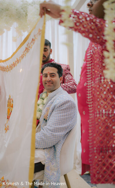 groom ceremony candid,wedding ritual veil,indian wedding traditions,groom smiling portrait,ceremony detail moment,cultural wedding ritual,soft fabric framing,wedding emotions candid,traditional ceremony setup,intimate moment
