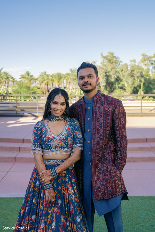 couple portrait outdoor,coordinated wedding outfits,blue lehenga bride,groom embroidered kurta,modern indian fashion,pre wedding portraits,stylish couple pose,natural light portrait,engagement shoot,elegant couple styling