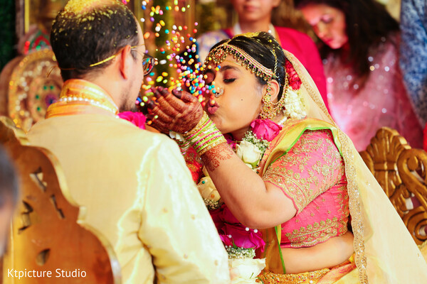 indian wedding ritual fun,bride playful moment,ceremony traditions india,candid wedding laughter,couple ritual moment,colorful wedding tradition,joyful ceremony shot,cultural wedding customs,bride groom interaction,festive wedding vibe