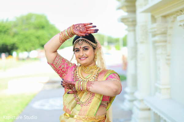 bride mehndi pose,south indian bride portrait,colorful bridal saree,henna hands bride,bridal jewelry gold,traditional bridal look,candid bridal joy,pre ceremony moment,cultural wedding fashion,expressive bride