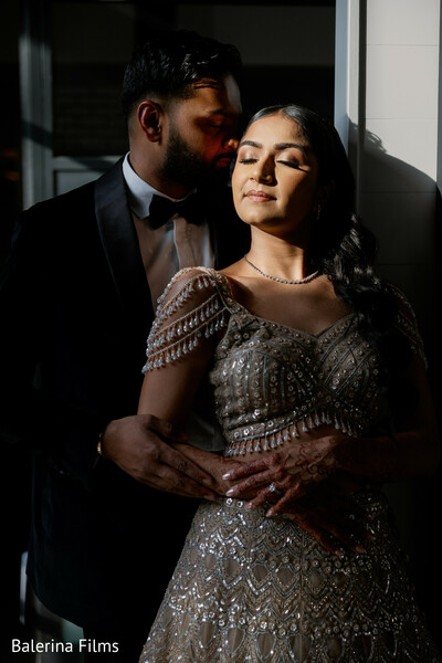 romantic close up couple,groom holding bride,dramatic lighting wedding,emotional wedding moment,reception portrait,elegant couple pose,intimate wedding photo,indian couple romance,luxury styling,love connection