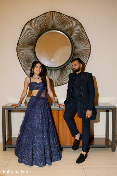 indoor couple portrait,navy outfit couple,modern indian fashion,sangeet outfit couple,editorial wedding photo,stylish couple pose,coordinated outfits,luxury wedding aesthetic,contemporary portrait,elegant styling