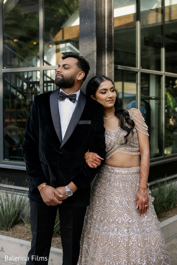 couple portrait modern indian wedding,black tux groom,champagne lehenga bride,editorial wedding style,outdoor portrait,elegant couple pose,luxury wedding fashion,contemporary indian couple,romantic portrait,stylish wedding look