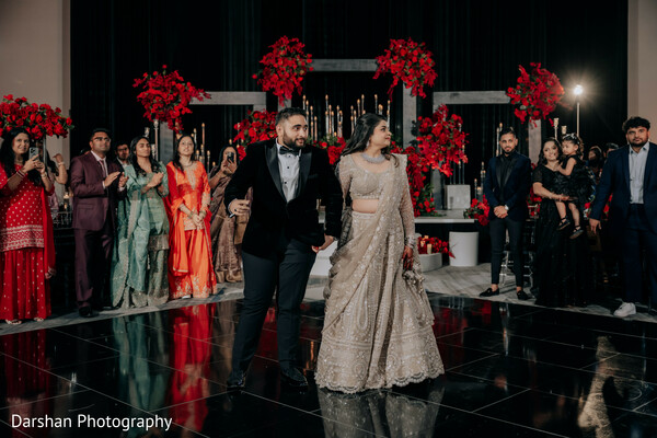 wedding dance floor,reception celebration,couple entrance,indian wedding reception,guests cheering,party moment,bride and groom,dance floor moment,celebration vibe,wedding party