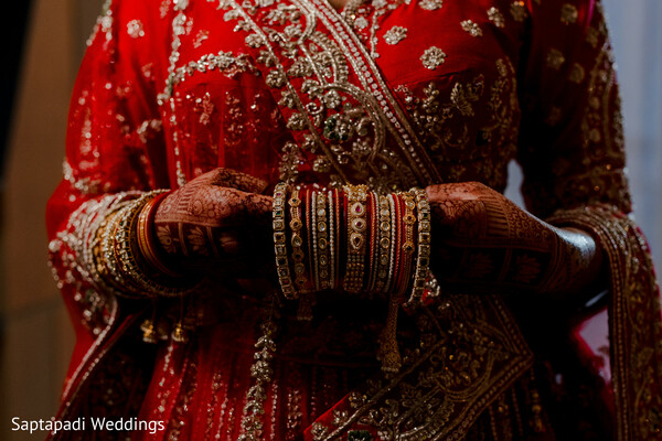 bridal lehenga,red wedding attire,bridal bangles,wedding jewelry,embroidered details,traditional bride,bridal fashion,luxury wedding,south asian bride,bridal elegance