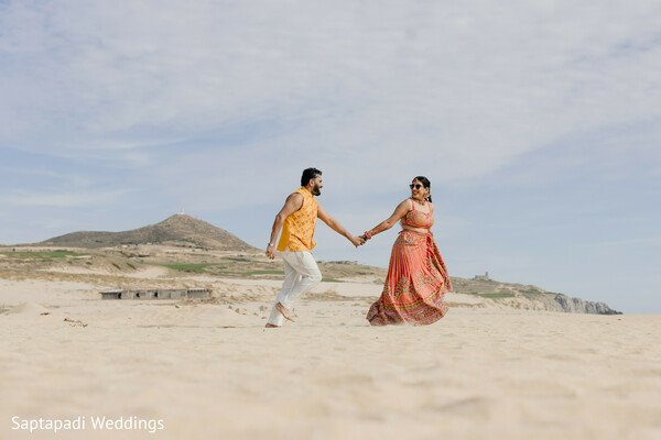 beach portraits,destination wedding,romantic stroll,flowing lehenga,sandy dunes,couple photography,coastal romance,pre wedding session,hand in hand,outdoor portraits