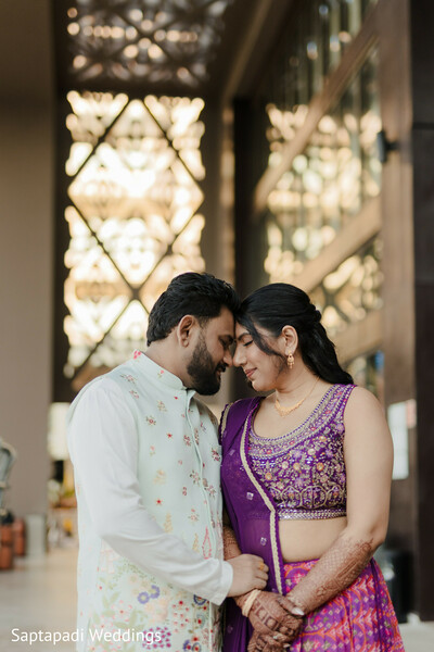 romantic portrait,couple connection,purple lehenga,ivory sherwani,intimate moment,destination resort,pre wedding portraits,traditional attire,emotional connection,elegant architecture