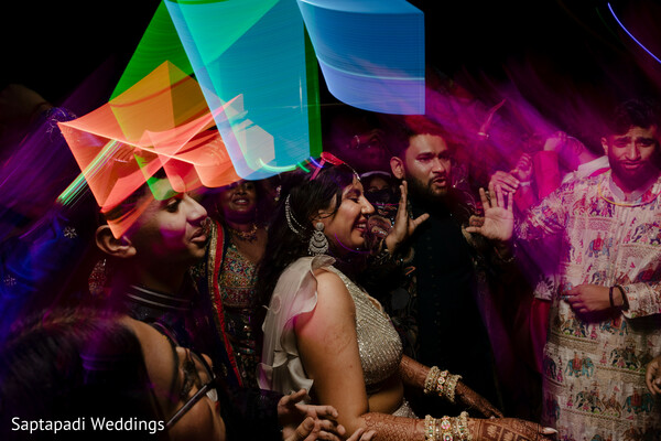 dance floor,sangeet celebration,colorful lights,wedding party,nightlife photography,reception dancing,festive atmosphere,wedding entertainment,candid moments,vibrant celebration