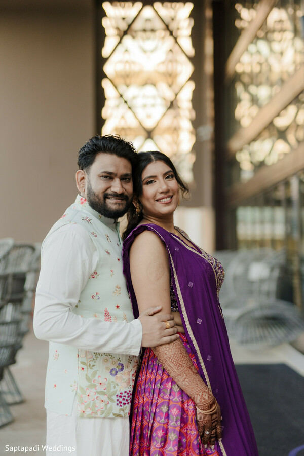 couple portrait,purple lehenga,floral sherwani,romantic pose,destination wedding,smiling couple,traditional attire,wedding photography,elegant portraits,south asian wedding