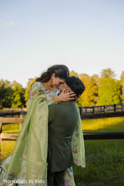 romantic embrace,outdoor portraits,pastel lehenga,sage green suit,countryside romance,couple connection,engagement session,garden wedding style,intimate moments,south asian couple