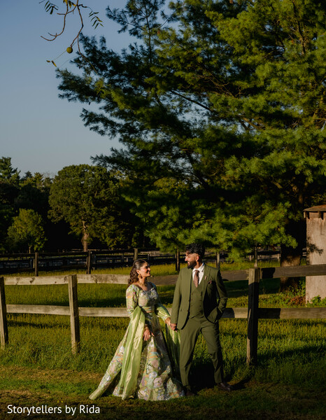 countryside portraits,hand in hand,rustic venue,floral lehenga,groom fashion,outdoor romance,estate wedding,engagement photography,natural moments,south asian couple