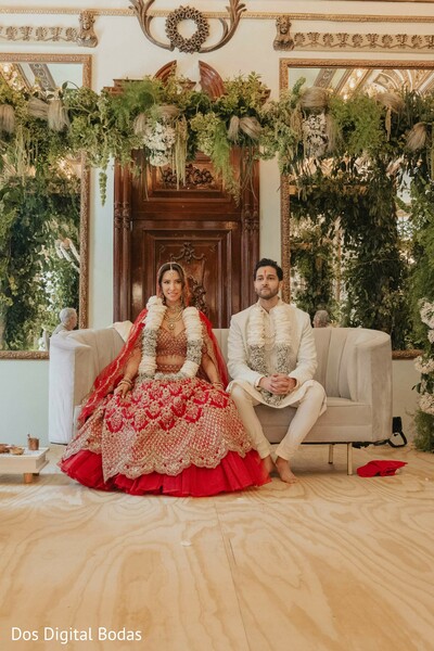 wedding ceremony,floral garlands,mandap decor,traditional wedding,bride and groom,cultural traditions,luxury ceremony,red lehenga,ivory sherwani,wedding portraits